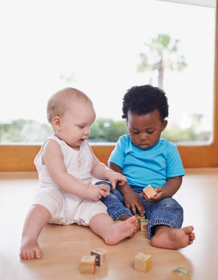 learning-growing-together-shot-two-adorable-babies-playing-with-building-blocks